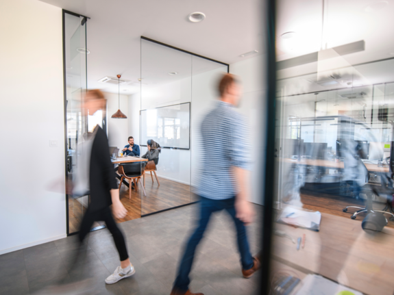 people walking in an office